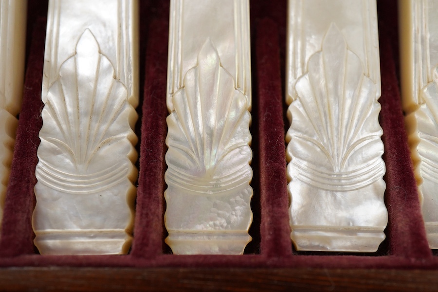 A set of twelve pairs of early Victorian mother of pearl handled dessert eaters, by Aaron Hadfield & Sons, Sheffield, 1838, no date letter on the forks, knife 19.1cm, housed in a mahogany canteen.